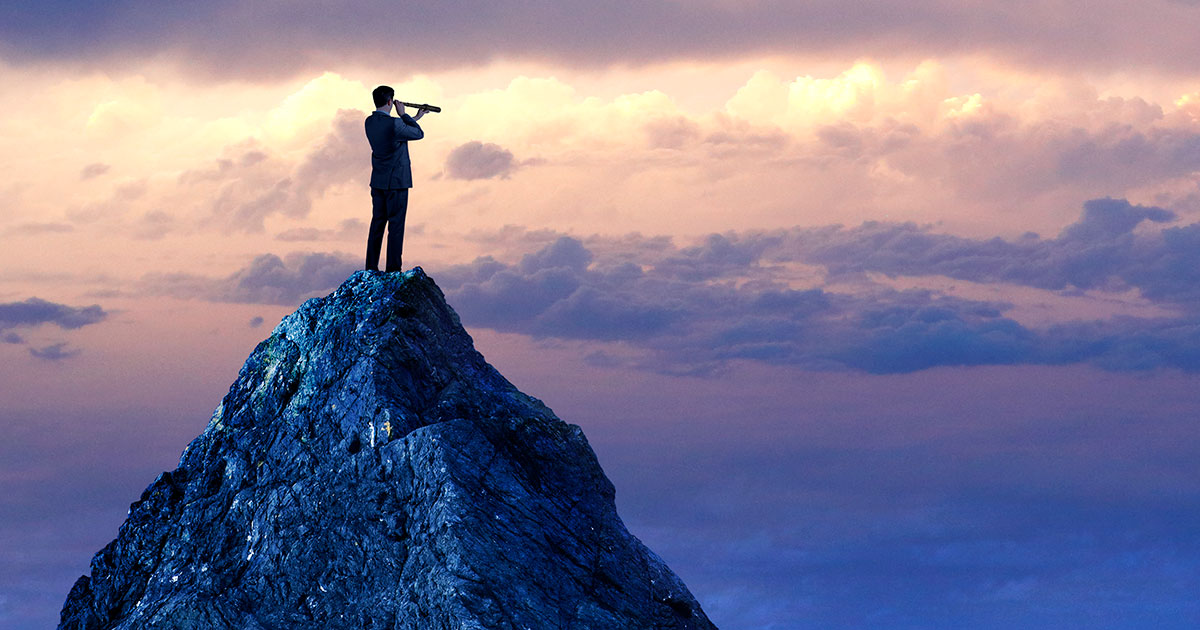 person viewing horizon from mountaintop