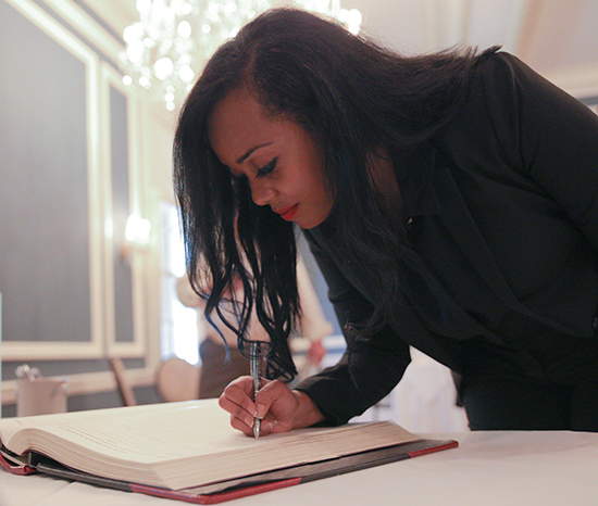 Bethesda Zewdie signs the book