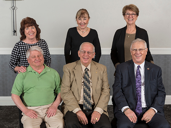 Thomas Kubasta, Claude Held II, and James Olson with their wives