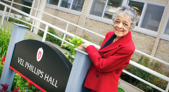 Vel Phillips next to sign for Vel Phillips Hall on UW-Madison campus