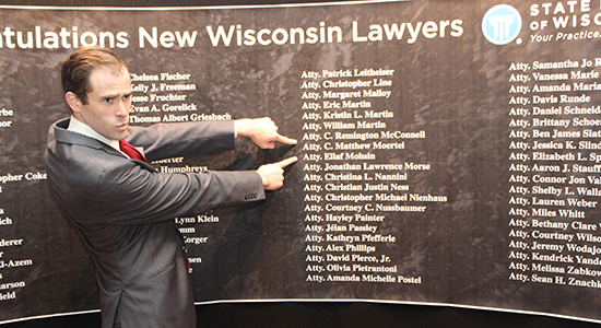 Matthew Moertel points to his name on the name wall.