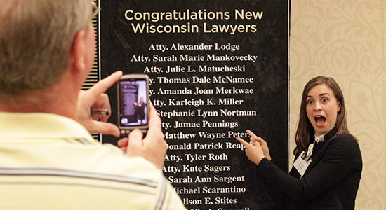 New Wisconsin lawyer Jamae Pennings points to her name at the reception.
