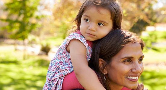 daughter on mother's shoulders