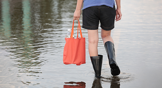 woman walking through flood water