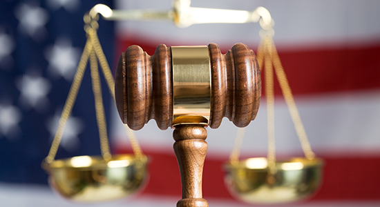 gavel in front of scales and American flag