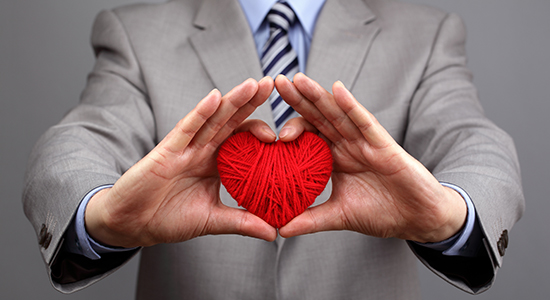 businessman holding a heart