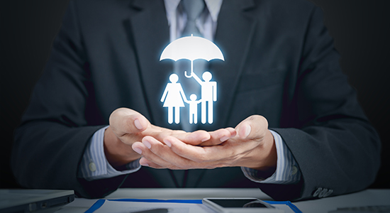 insurance company holding family with umbrella