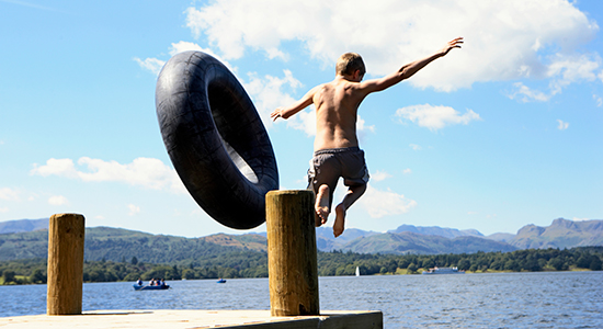 boy jumps into lake