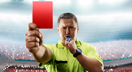 soccer referee pulls a red card