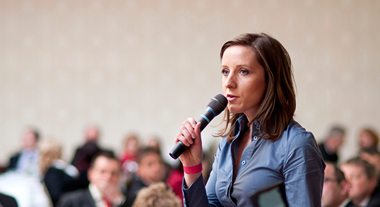 women speaks to an audience