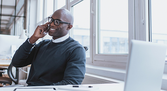 business owner talks with friend by phone