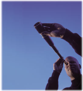 man looking through a  telescope