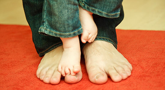father and baby feet
