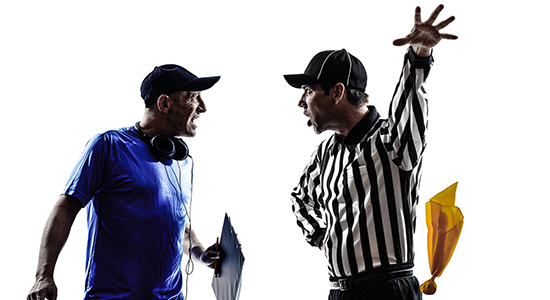 football coach arguing with referee