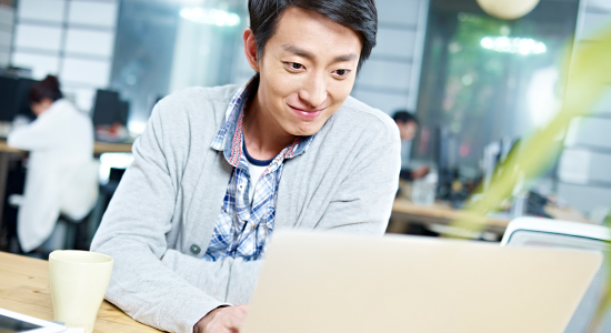 man sitting at computer