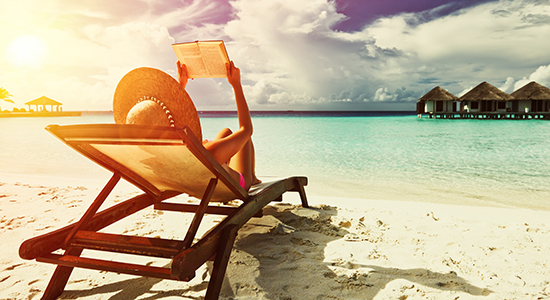 woman reading on beach