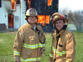 fire fighters in front of buring building