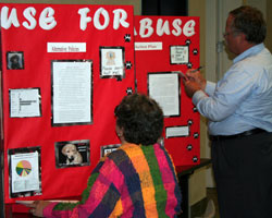 Volunteer judge gives feedback on a Project Citizen   portfolio.