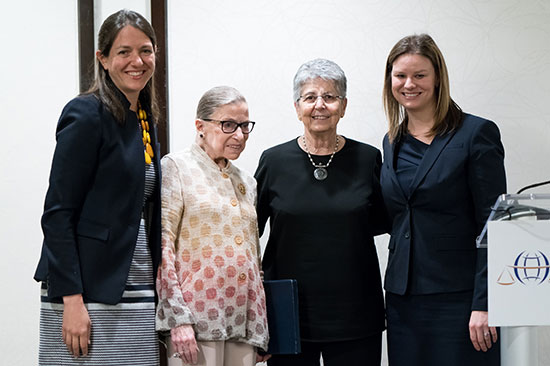 Shana Tabak poses with U.S. Supreme Court Justice Ruth Bader Ginsberg and panel members