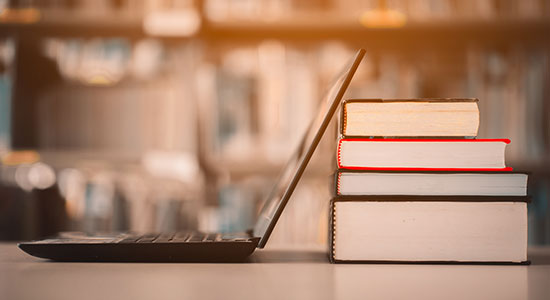 laptop and library books