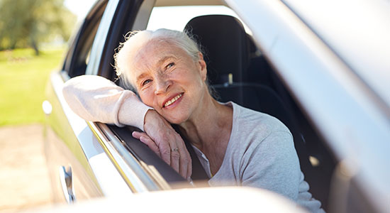 elderly woman inside a car