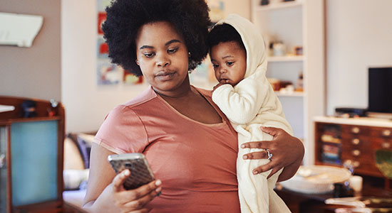 concerned mother with child looking at phone