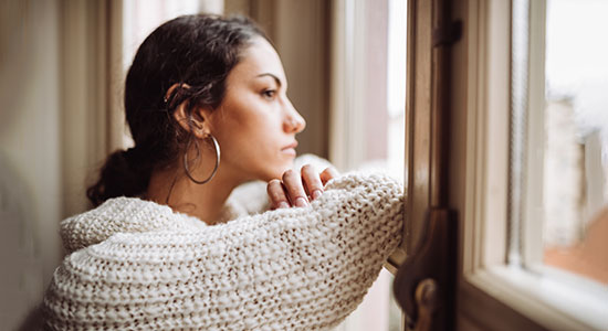 abuse survivor looks out window