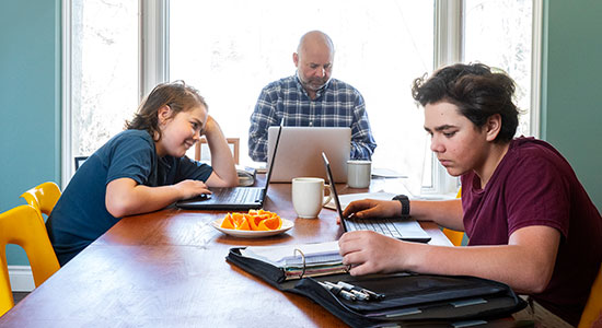 family working at kitchen table
