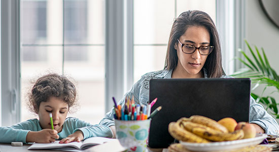 woman and girl working at table