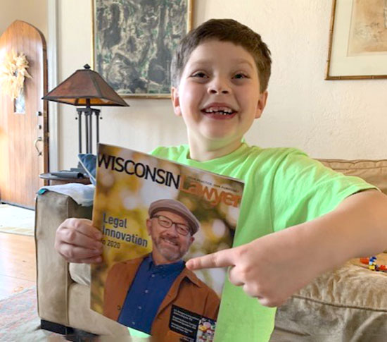 boy with Wisconsin Lawyer magazine