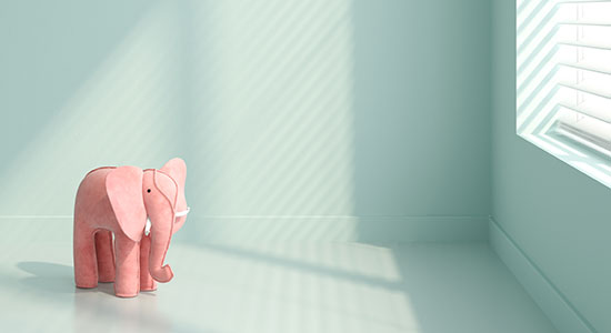 sad stuffed elephant in a room