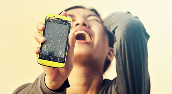 woman crying over broken phone