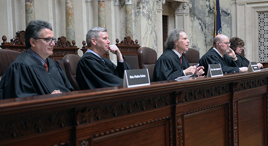 Judge Stephen Crocker, center, questions a student attorney during the 2018 High School Mock Trial championship round in March 2018.