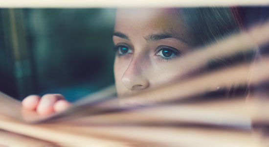 woman peeking out window